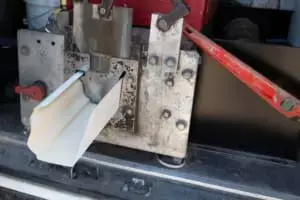 machine forming aluminum gutters into shape