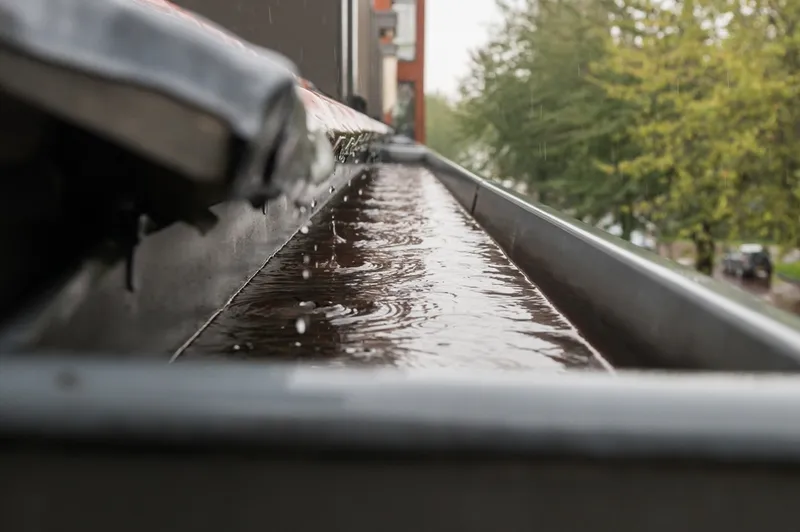 rain draining from roof into gutter